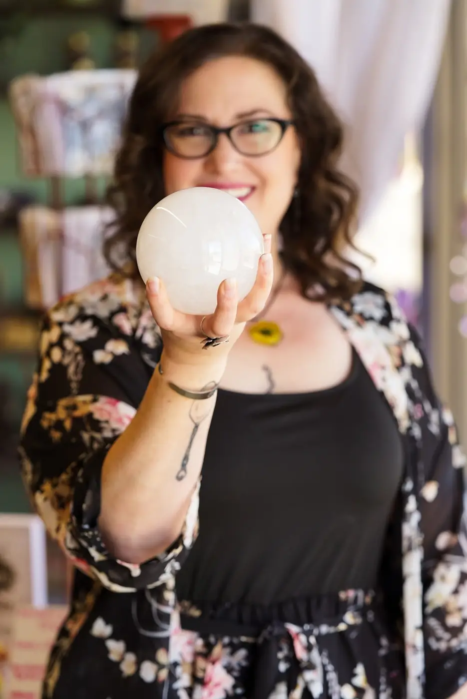 Emily Hart holding a crystal sphere
