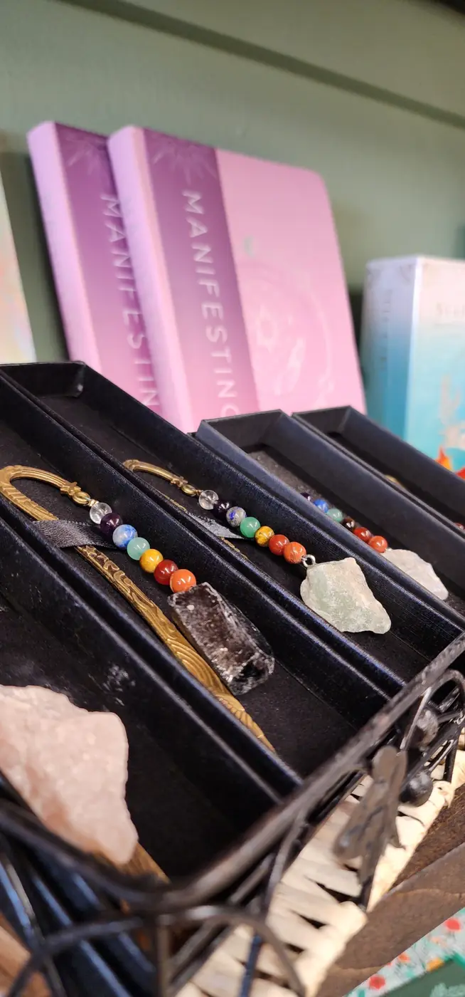 Stone bracelets and raw crystals in a display tray