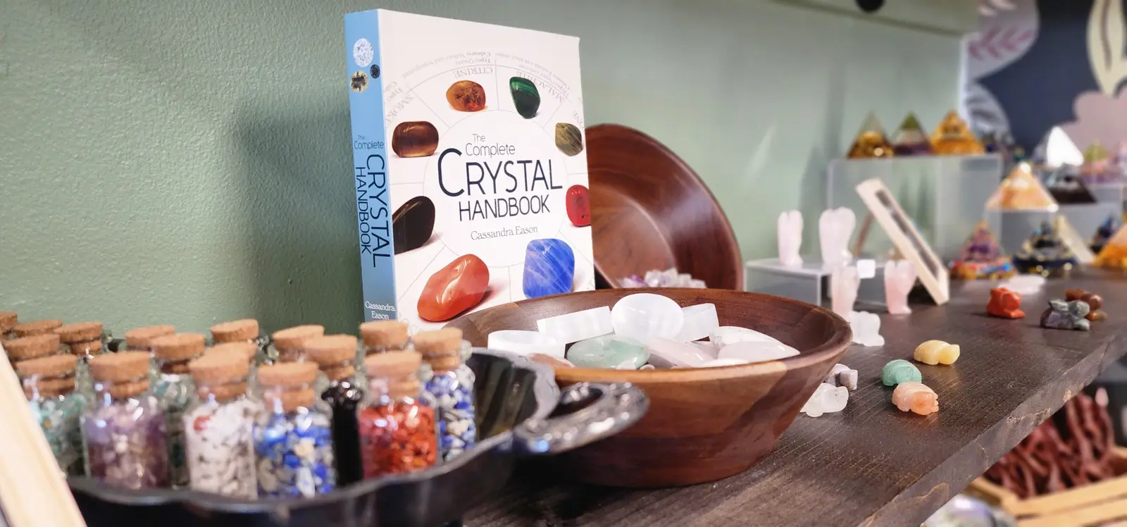 The Crystal Handbook with bowls of tumbled stones