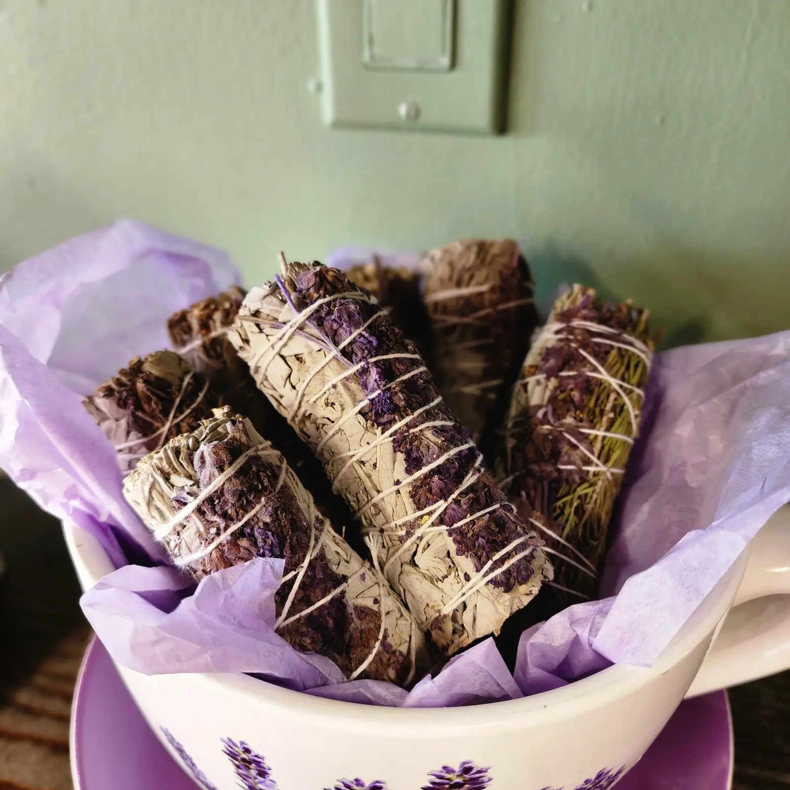 Lavender and sage bundles in a teacup