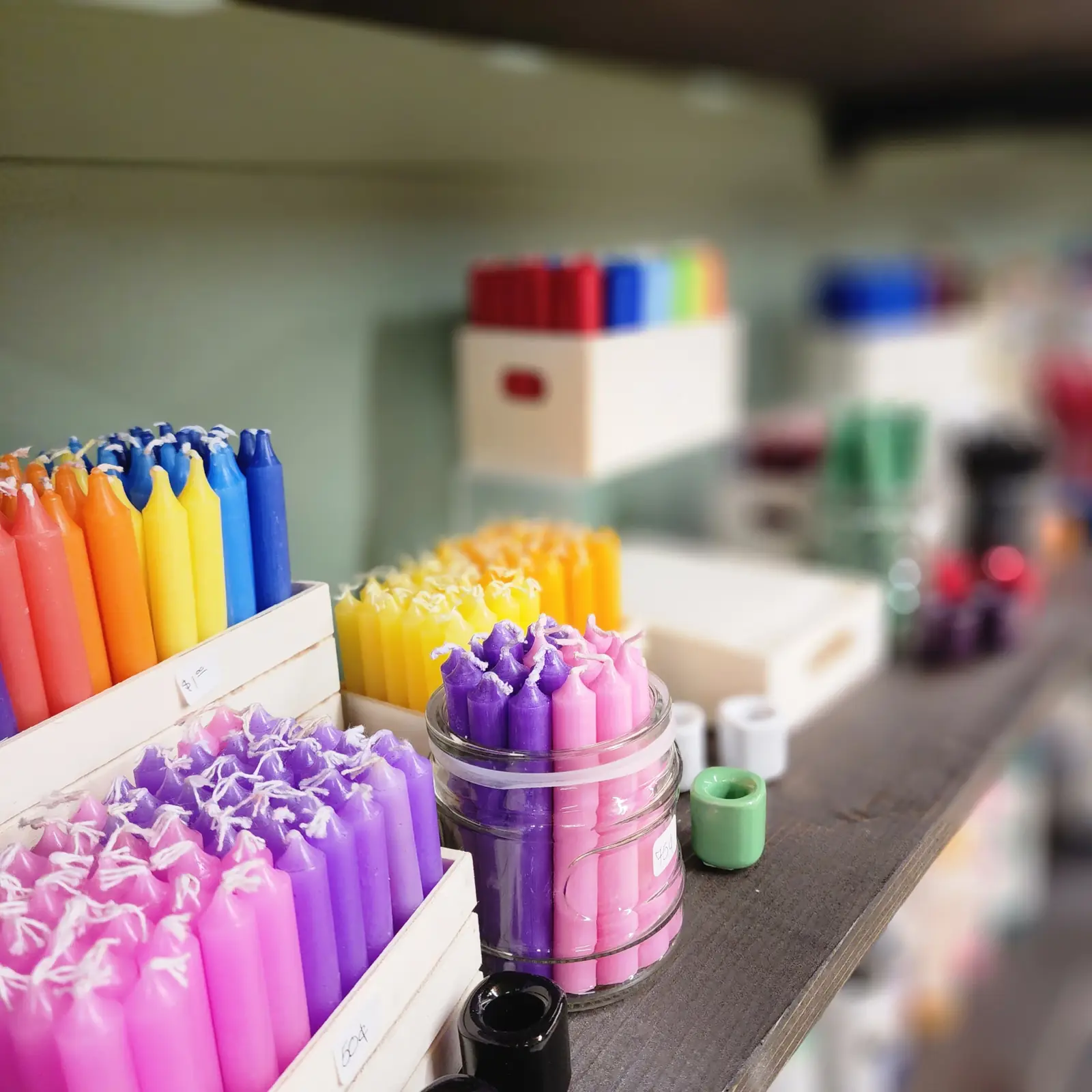 Colorful spell candles in boxes at Indigo Thrive
